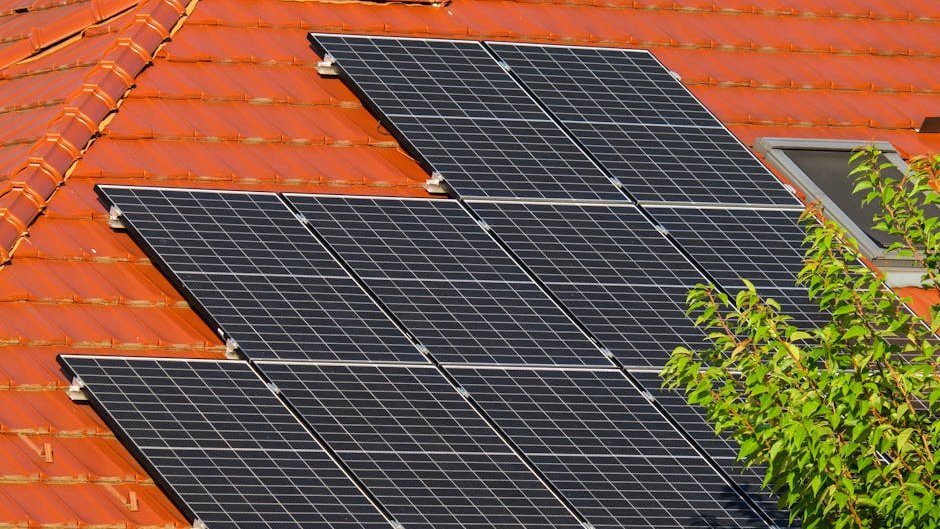 Close-up of solar panels on a red tiled roof in Croatia, highlighting renewable energy.